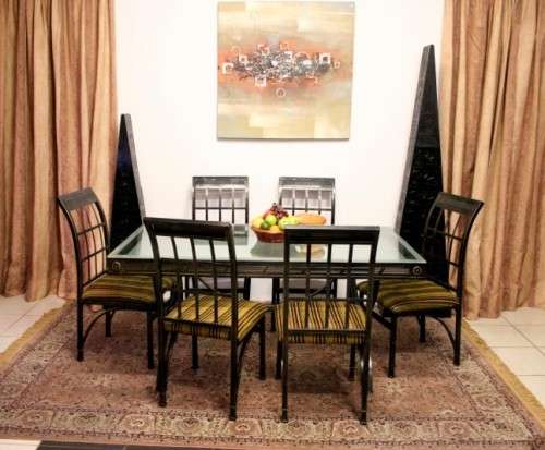 Make an offer! Quality 6-seater wrought iron patio table w 6 upholstered chairs. Summer is here!!!