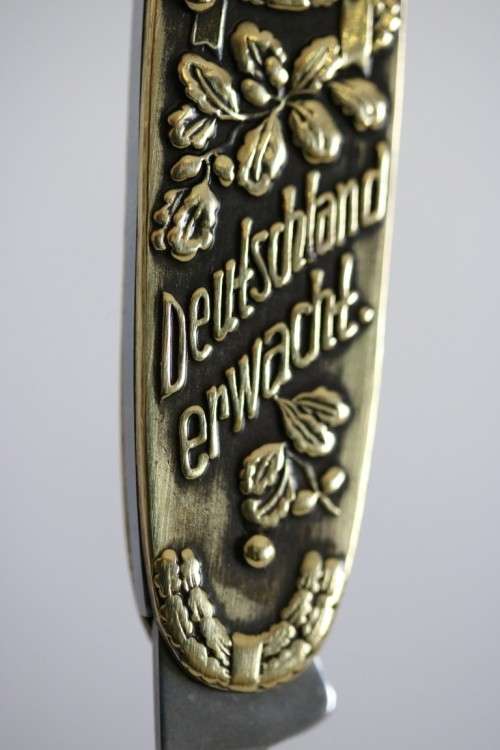 A well-made brass "Solingen, Germany" pocket knife depicting Adolf Hitler - in very good condition!
