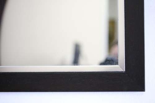 A stylish modern dark wood rectangular wall mirror with brushed steel detailing -  RS17M