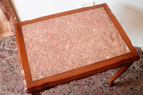 A wonderful and stylish teak side table with a marble top and beautifully carved detailing