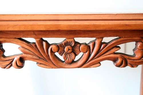A wonderful and stylish teak side table with a marble top and beautifully carved detailing