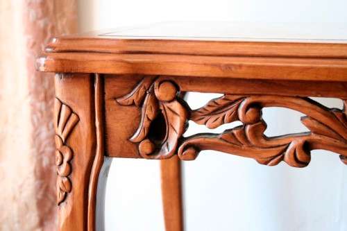 A wonderful and stylish teak side table with a marble top and beautifully carved detailing