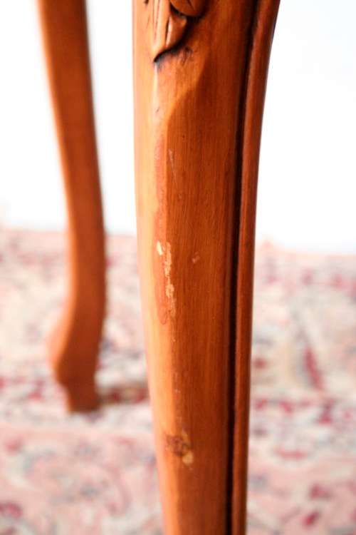 A wonderful and stylish teak side table with a marble top and beautifully carved detailing