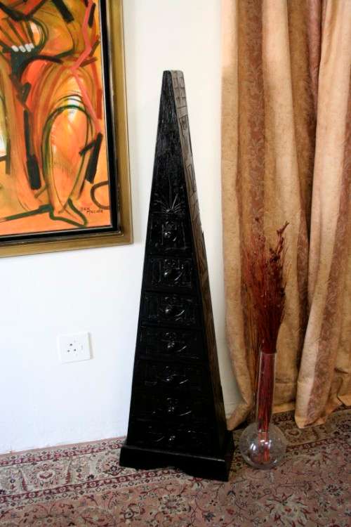 A beautiful tall Indonesian pyramid chest of drawers with stunning traditional hand carved detailing