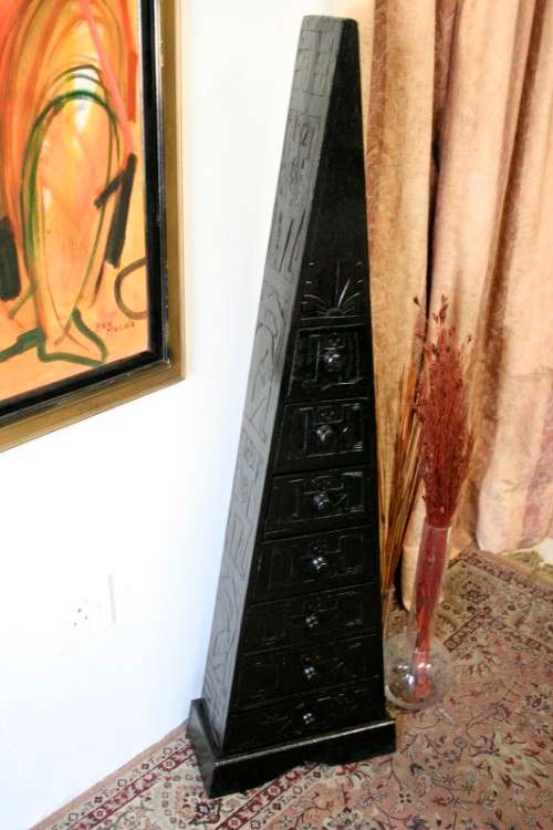 A beautiful tall Indonesian pyramid chest of drawers with stunning traditional hand carved detailing