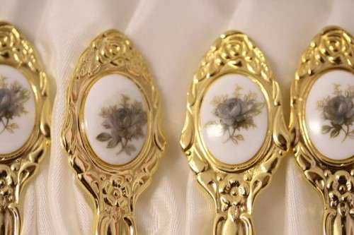 A superb boxed set of 12x Eetrite 24K gold plated (on stainless steel) teaspoons w/ blue rose decals