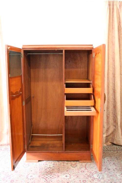 A stunning vintage double-door Oak wardrobe with racks and drawers.