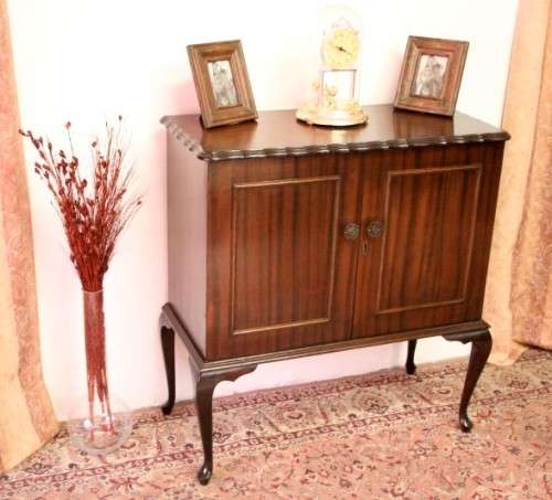 A beautiful, elegant vintage two-door Queen Anne TV cabinet, ideal for compact spaces.