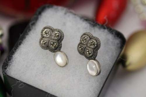 A pretty pair of Art Deco styled ladies fashion earrings with marcasite stones and a opal bead stone