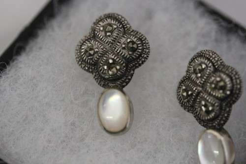 A pretty pair of Art Deco styled ladies fashion earrings with marcasite stones and a opal bead stone