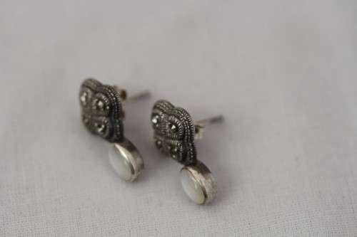 A pretty pair of Art Deco styled ladies fashion earrings with marcasite stones and a opal bead stone