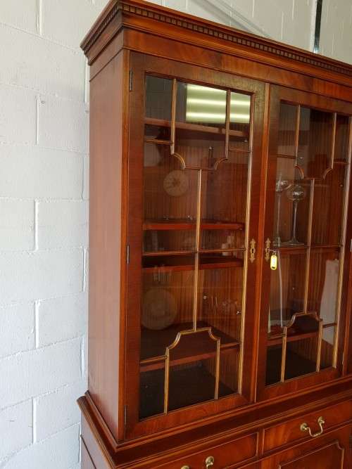 An exquisitely made "Rosjohn" three-glass door show cabinet with drawers and cupboard space