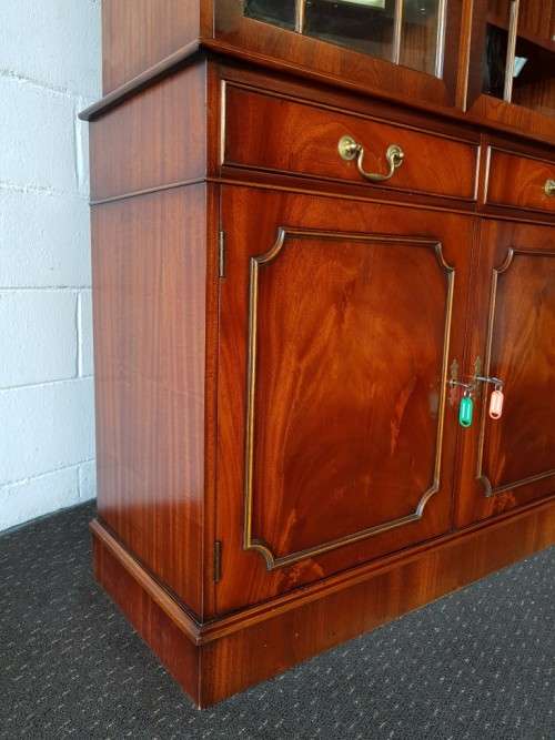 An exquisitely made "Rosjohn" three-glass door show cabinet with drawers and cupboard space