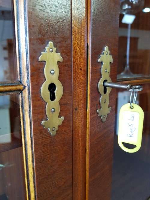 An exquisitely made "Rosjohn" three-glass door show cabinet with drawers and cupboard space