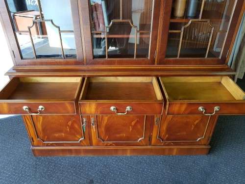 An exquisitely made "Rosjohn" three-glass door show cabinet with drawers and cupboard space