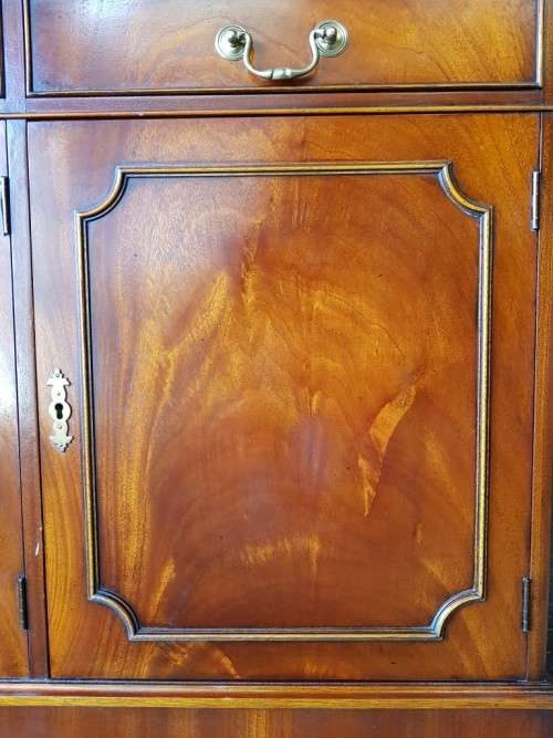 An exquisitely made "Rosjohn" three-glass door show cabinet with drawers and cupboard space