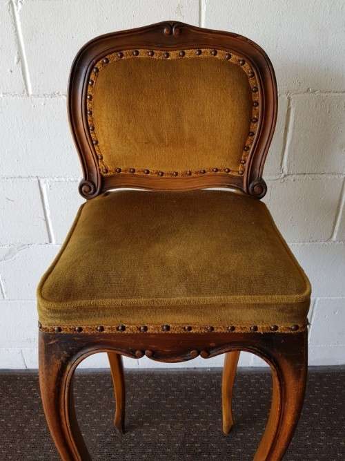 An amazing and unusual antique Mahogany bar chair with long legs and a mustard colour upholstery!!