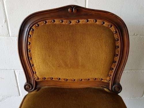 An amazing and unusual antique Mahogany bar chair with long legs and a mustard colour upholstery!!