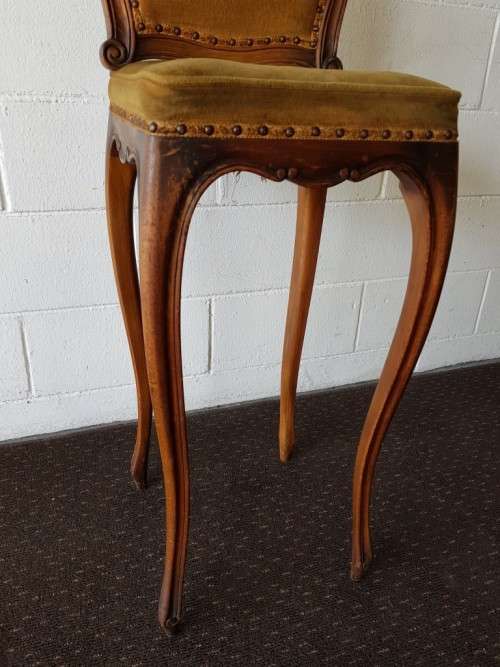 An amazing and unusual antique Mahogany bar chair with long legs and a mustard colour upholstery!!