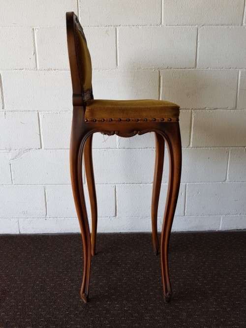 An amazing and unusual antique Mahogany bar chair with long legs and a mustard colour upholstery!!