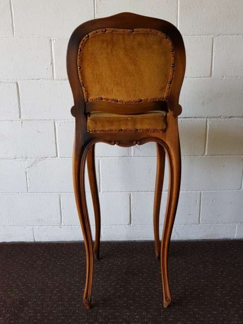 An amazing and unusual antique Mahogany bar chair with long legs and a mustard colour upholstery!!