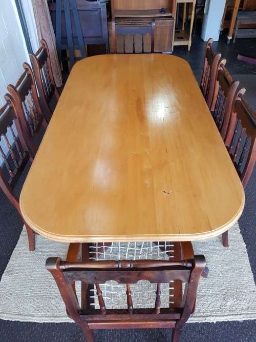 An amazing 8-seater Yellowwood and Imbuia dining suite with 8x stunning riempie dining chairs