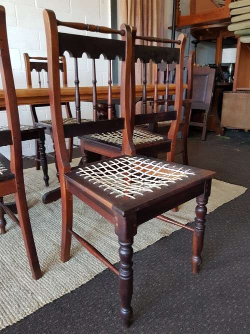 An amazing 8-seater Yellowwood and Imbuia dining suite with 8x stunning riempie dining chairs
