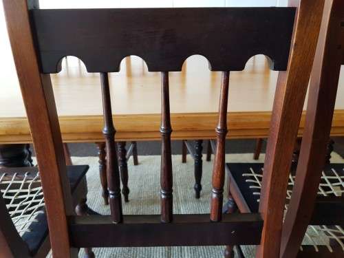 An amazing 8-seater Yellowwood and Imbuia dining suite with 8x stunning riempie dining chairs