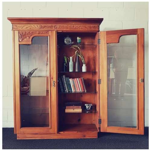 A magnificent vintage solid Oregon display cabinet with glass doors and shelves and hand carvings!!