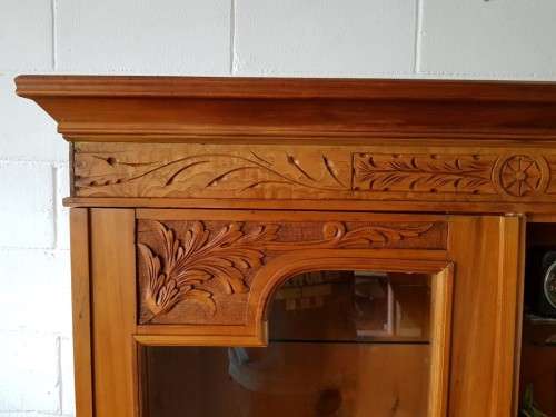 A magnificent vintage solid Oregon display cabinet with glass doors and shelves and hand carvings!!