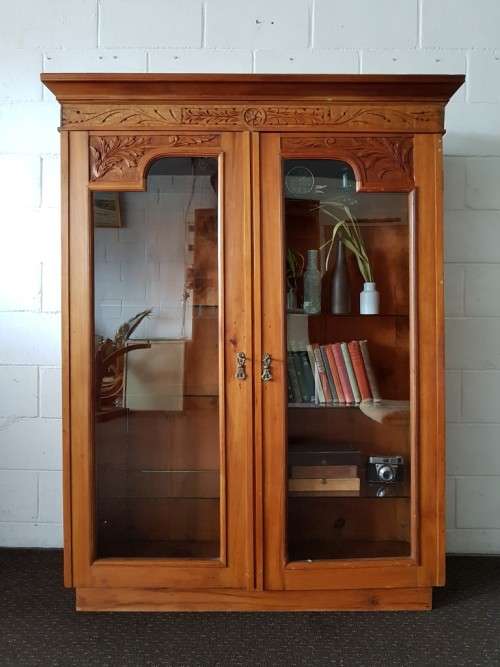 A magnificent vintage solid Oregon display cabinet with glass doors and shelves and hand carvings!!