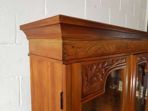 A magnificent vintage solid Oregon display cabinet with glass doors and shelves and hand carvings!!