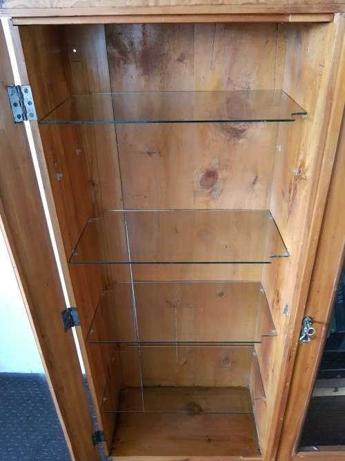 A magnificent vintage solid Oregon display cabinet with glass doors and shelves and hand carvings!!