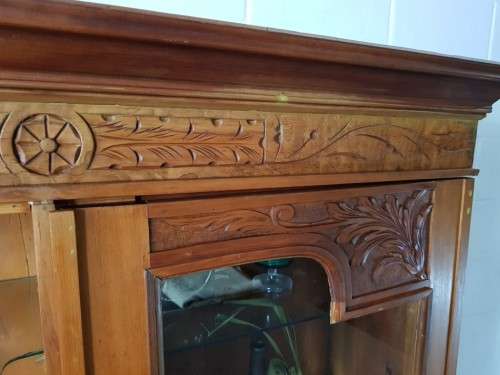 A magnificent vintage solid Oregon display cabinet with glass doors and shelves and hand carvings!!