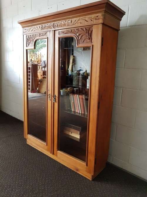 A magnificent vintage solid Oregon display cabinet with glass doors and shelves and hand carvings!!