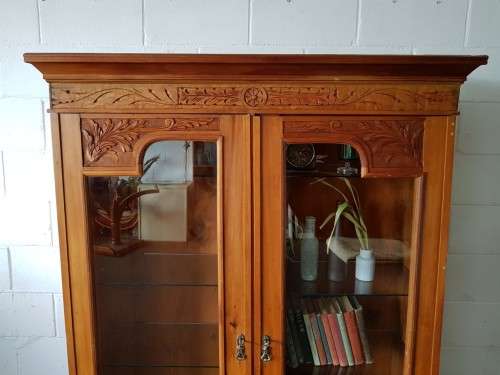 A magnificent vintage solid Oregon display cabinet with glass doors and shelves and hand carvings!!