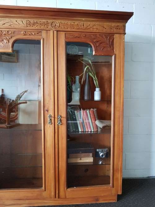 A magnificent vintage solid Oregon display cabinet with glass doors and shelves and hand carvings!!