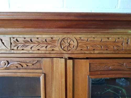 A magnificent vintage solid Oregon display cabinet with glass doors and shelves and hand carvings!!