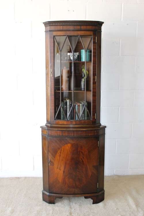 A fantastic Edwardian antique corner display cabinet with a glass door and spacious bottom cupboard