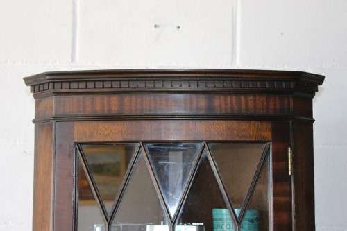 A fantastic Edwardian antique corner display cabinet with a glass door and spacious bottom cupboard
