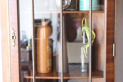 A fantastic Edwardian antique corner display cabinet with a glass door and spacious bottom cupboard
