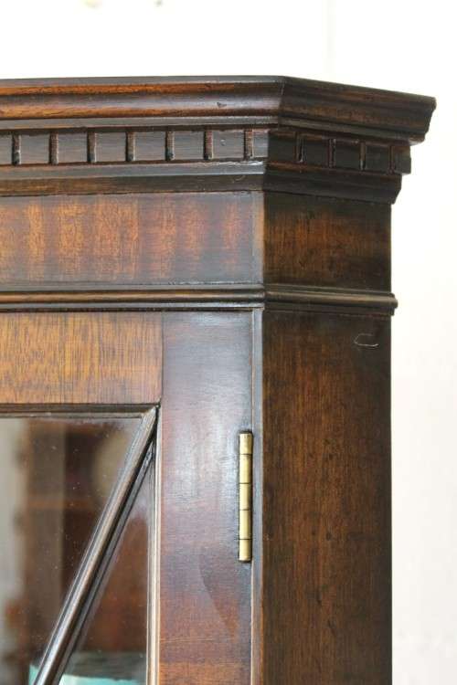A fantastic Edwardian antique corner display cabinet with a glass door and spacious bottom cupboard