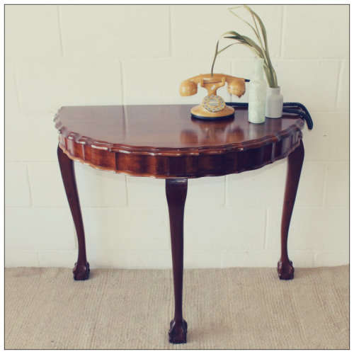 An amazing vintage (larger than normal) Stinkwood ball & claw half moon display/occasional table