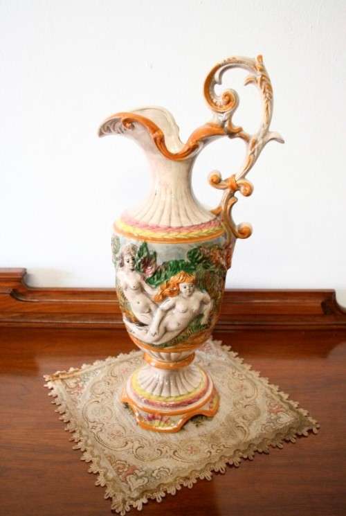 A beautiful large hand painted porcelain vase with a cherub scene