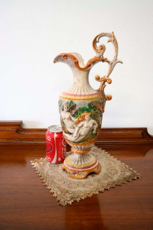 A beautiful large hand painted porcelain vase with a cherub scene