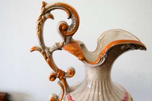 A beautiful large hand painted porcelain vase with a cherub scene