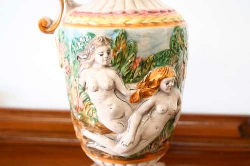 A beautiful large hand painted porcelain vase with a cherub scene