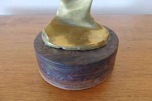 A beautiful tall ornamental brass abstract figurine on a wooden stand in wonderful condition