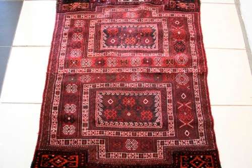 A spectacular (1.10m x 2.54m) Turkish Kilim carpet with reds, pinks, black & white colours