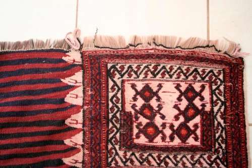 A spectacular (1.10m x 2.54m) Turkish Kilim carpet with reds, pinks, black & white colours